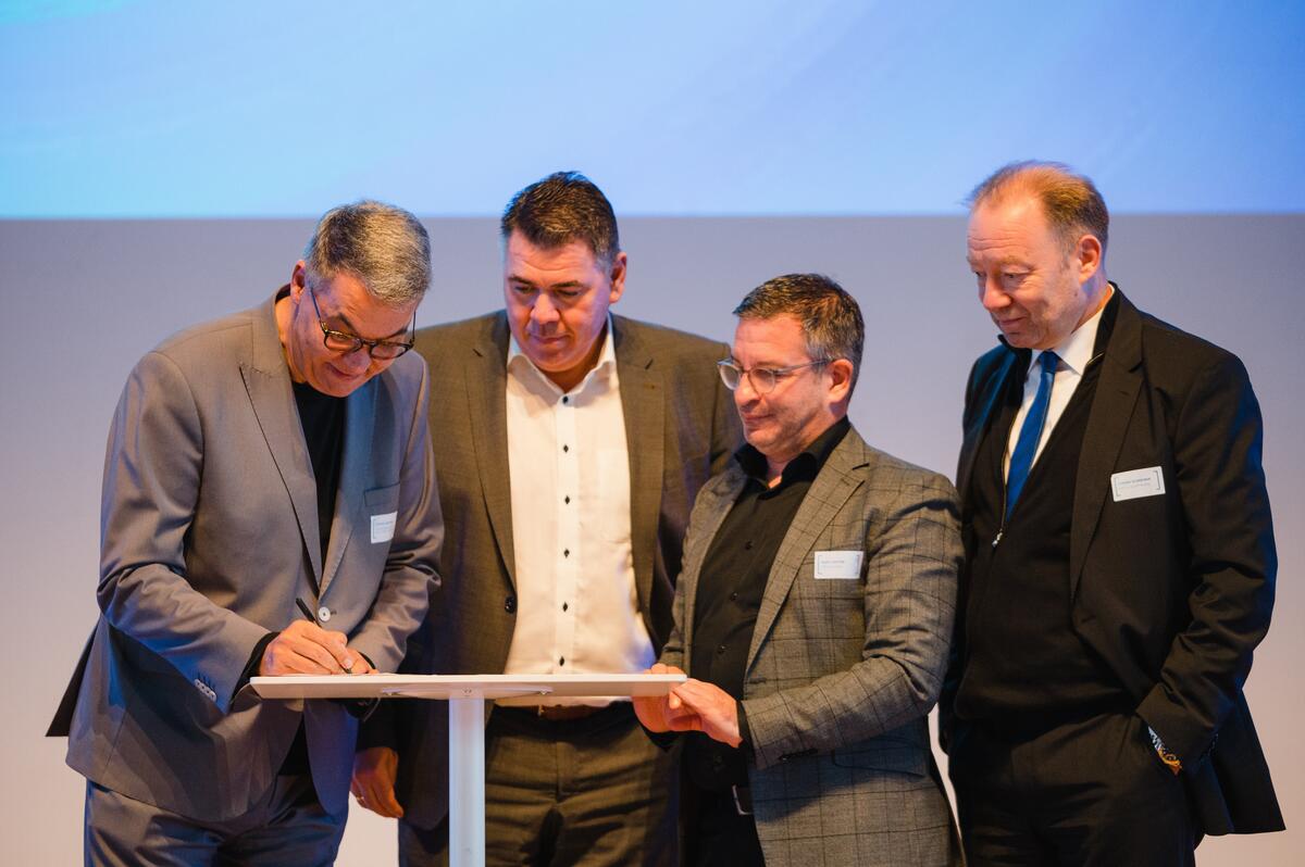 Bild vergrößern: OB Westphal, LR Löhr, OB Herter und  IHK-Chef Schreiber bei der Unterschrift.